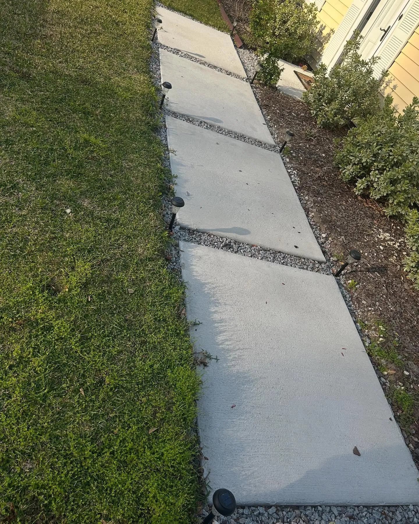 Close-up of finished concrete pads with gravel drainage between them