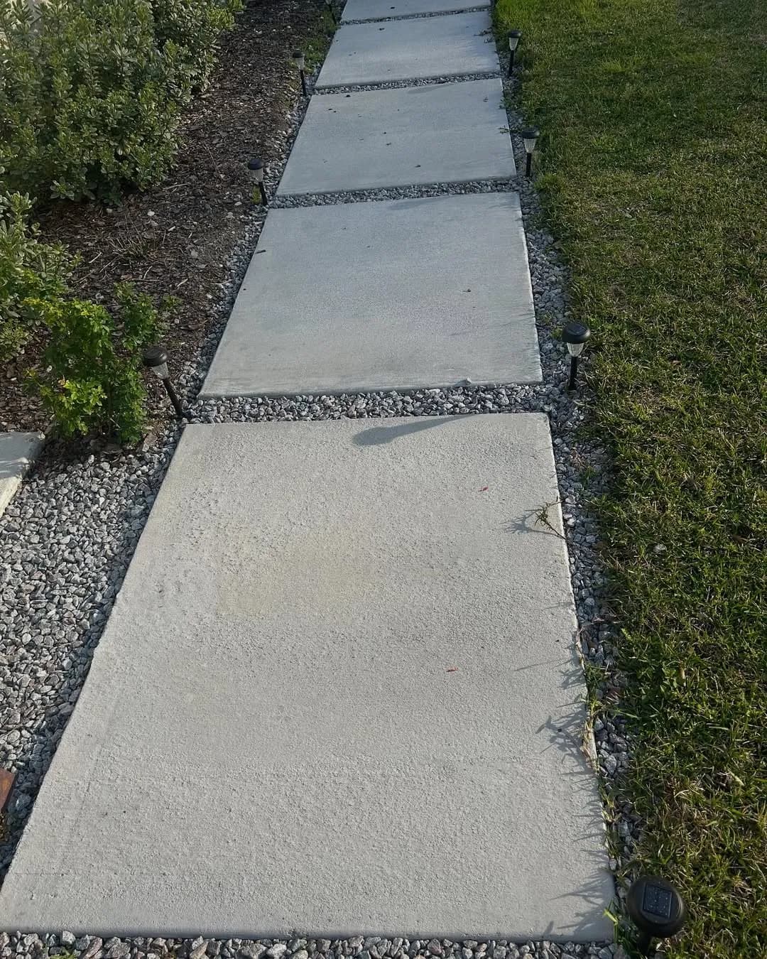 Modern walkway with clean lines and natural gravel borders