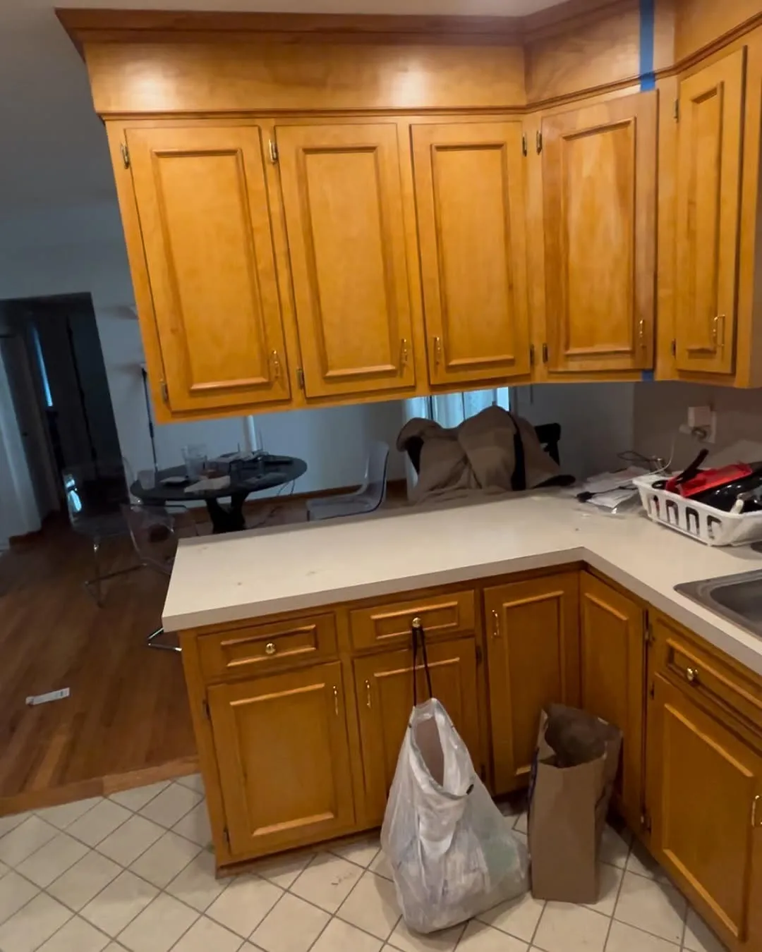 Dated oak upper cabinets and old countertops in the kitchen